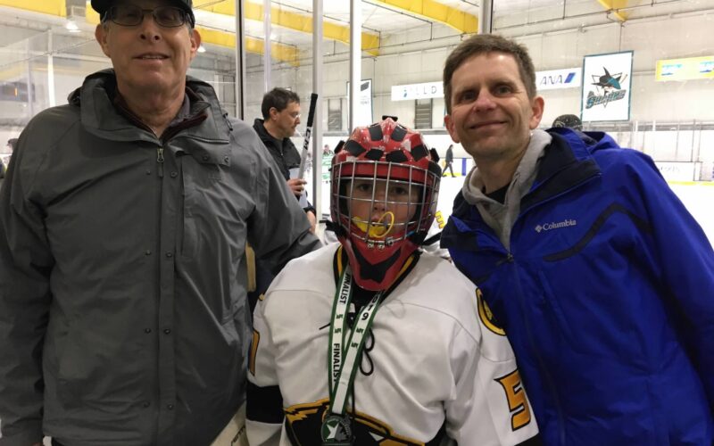 Jenni Mangel's son, Evan, with his father and grandfather.